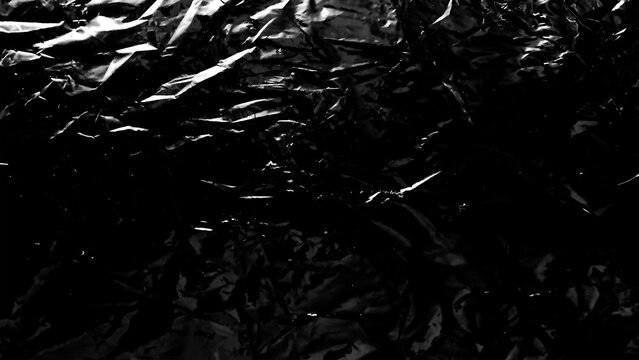 Plastic wrap texture overlay effect on black background. Shrink wrapped plastic sleeve for cover