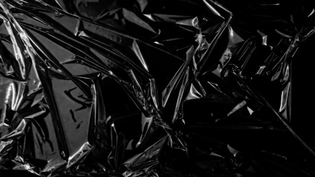 Plastic wrap texture overlay effect on black background. Shrink wrapped plastic sleeve for cover