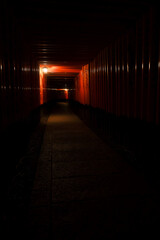 Fototapeta premium Mysterious night view of endless red Torii gates pathway at Fushimi Inari Shrine in Kyoto
