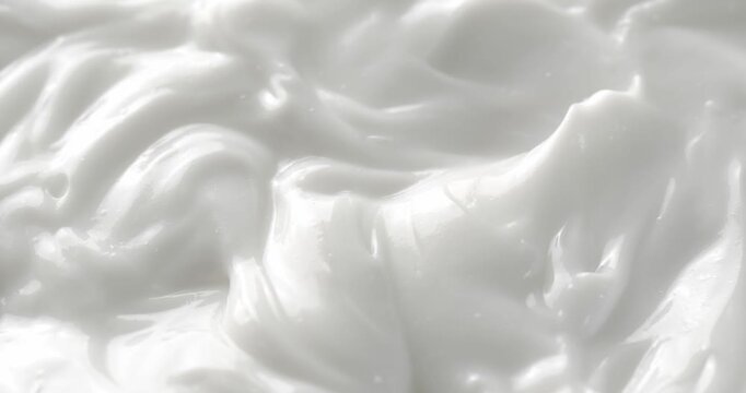 Cosmetic smears of creamy texture. Cosmetic skin cream. Beauty skincare product sample. Close-up footage of cream texture on rotating table