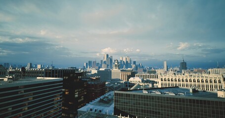 Fototapeta premium Golden sunset glow, Serene twilight scene with illuminated rooftops, Sundrenched cityscape during dusk with peaceful ambiance and glowing windows