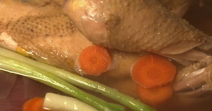 Organic chicken broth is boiling. Homemade chicken broth. Chicken soup.