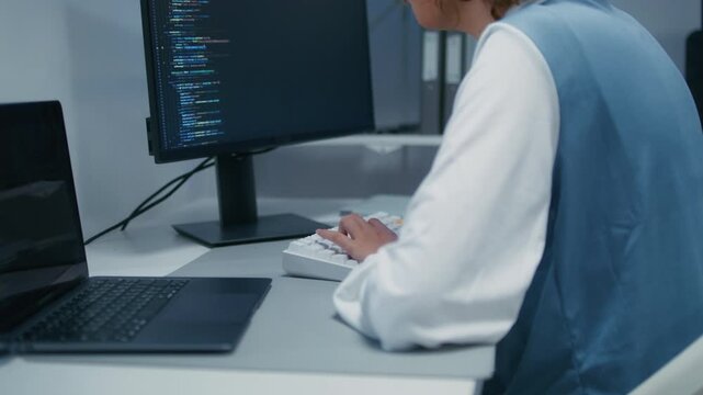 Software Engineer, AI Programmer Software Developing, Focused Female Computer Programmer working on Computer Writing Code, Developing software application looking at Screen in Tech Office at night.