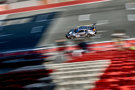 UAE, Dubai, 18 January 2026: 24h series racing supercars on the circuit, Battle of the teams, long exposure photography, supercars drive past at high speed, pitstops, training runs, watching people, 