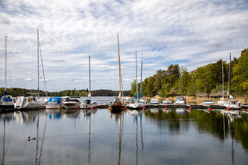 Boats and yachts at a pier on a lake on a summer day