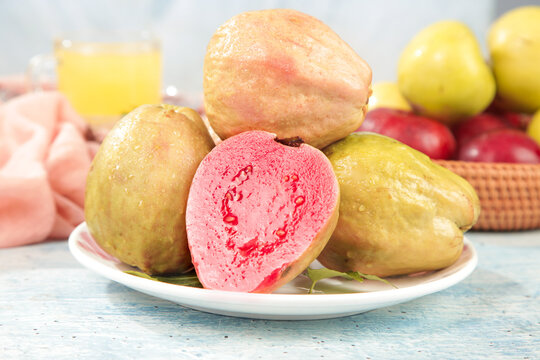 Fresh Red Guava Fruits from Guangxi China on White Plate - Tropical Asian Fruit with Pink Flesh