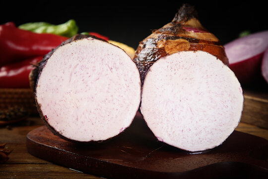 Fresh Taro Root Slices from Guangxi China on Wooden Board with Vegetables