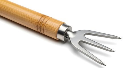 Fototapeta premium A close-up of a meat fork with a wooden handle and serrated metal tines on a white surface.