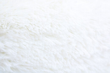 Serene interior scene highlighting plush white blanket with tactile detail and warm accents © Vera Aksionava