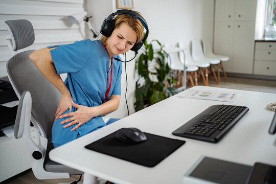 Female call center agent suffering from severe back pain
