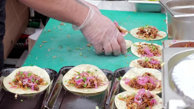 Festival chef tacos, Vibrant fair serving tasty tacos, Energetic event with quick taco construction, Vibrant festival features skillful cooking and tasty taco assembly