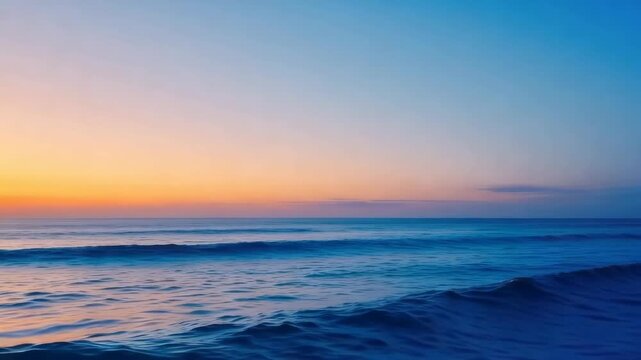 Ocean waves rolling during peaceful sunset at the beach with vibrant colors in sky background