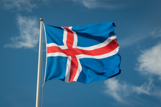 Flag of Iceland waving against blue sky