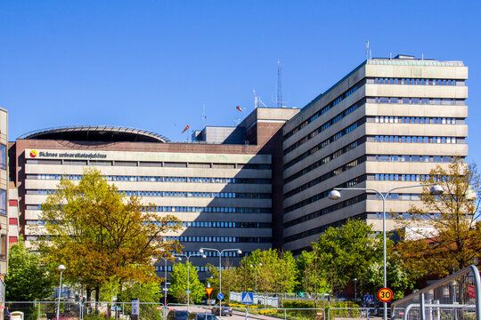 Lund, Sweden - May 11 2019: Exterior view of the large Skane University Hospital building complex featuring a rooftop helipad against a clear blue sky
