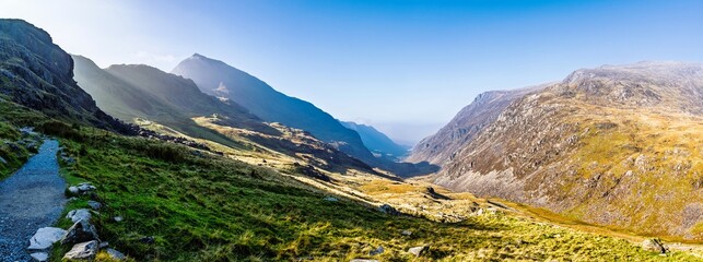 Fototapeta premium Autumn colours of Pen-y-Pass over Miner’s Track - Start Point and road A4086, Snowdonia, Wales, UK