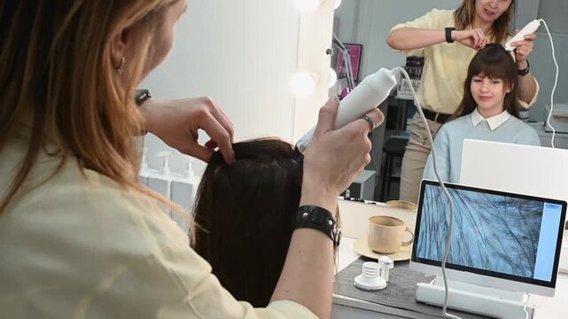  closeup scalp examination using trichoscope reveals alopecia, dandruff and seborrhea. Specialist analyzes hair structure on monitor. Professional approach to hair diagnostics. Hair loss oily scalp
