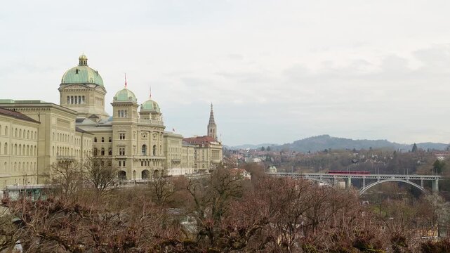 South Side of Federal Palace of Switzerland and Tram Going on Kirchenfeldbrucke Bridge. Bern, Switzerland. View from Kleine Schanze