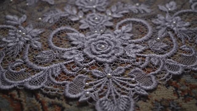Close-up of gray floral lace fabric with sparkly details