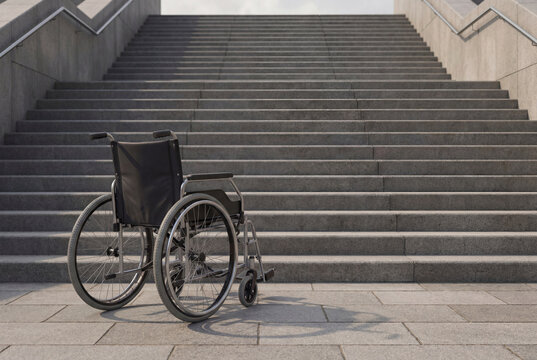 Empty wheelchair positioned at bottom of concrete stairs, symbolizing mobility challenges, lack of inclusive infrastructure, disability rights awareness, and barrier to equal access.