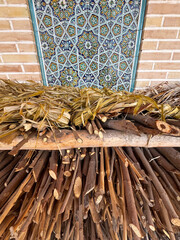 A pile of wood is stacked on a wooden bench