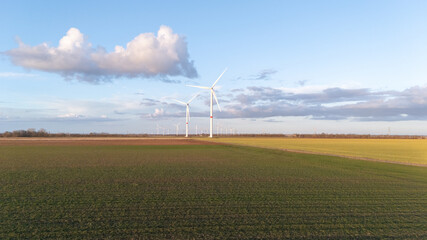 Obraz premium A wind farm with three wind turbines in the distance
