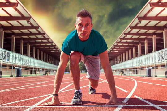 Athlete in starting block position ready for race at stadium