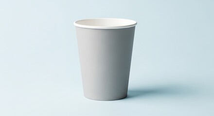 A single plain gray paper cup with a white rim stands against a light blue background.