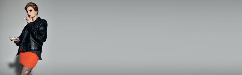 Young beautiful woman showcases bold fashion in a striking urban setting during golden hour