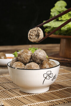 Chaoshan Handmade Beef Balls Traditional Chinese Soup Dumplings with Chopsticks and Vegetables