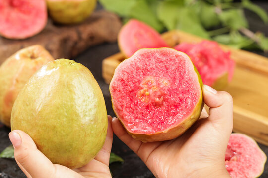 Fresh Red Guava Fruit Cut in Half Showing Pink Flesh - Tropical Asian Fruit from Guangxi