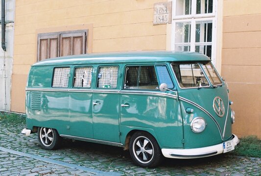 Vintage green Volkswagen T1 Splitscreen bus in Prague, analog photography