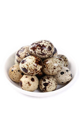 Fototapeta premium Fresh Quail Eggs with Speckled Shells on White Plate - Rich Protein Delicious Farm Food