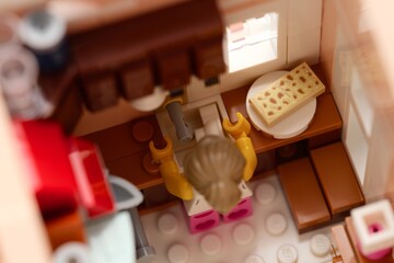 Fototapeta premium Tambov, Russian Federation - February 11, 2026 Lego woman minifigure standing near the sink in her kitchen.
