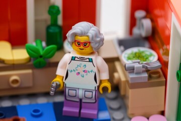 Fototapeta premium Tambov, Russian Federation - January 27, 2026 Lego grandmother minifigure cooking dinner in his kitchen. Close-up