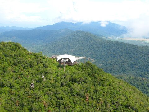 Aerial view of Langkawi SkyCab and SkyBridge above lush rainforest mountains in Malaysia.