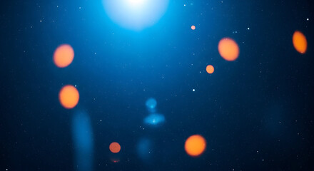 Blurry image of orange lights against a dark blue background