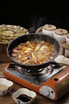 Braised Fish Cooking in Wok on Gas Stove - Traditional Asian Cuisine Preparation