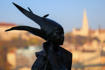 Fototapeta premium Statue of a little princess against the city skyline . Budapest, Hungary.