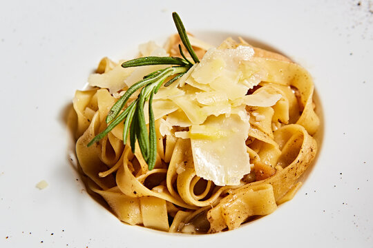 Classic Italian tagliatelle pasta with aromatic fresh rosemary and shaved Parmesan cheese