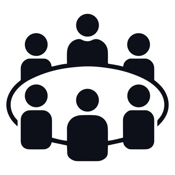 Group of people sitting around a table in a meeting