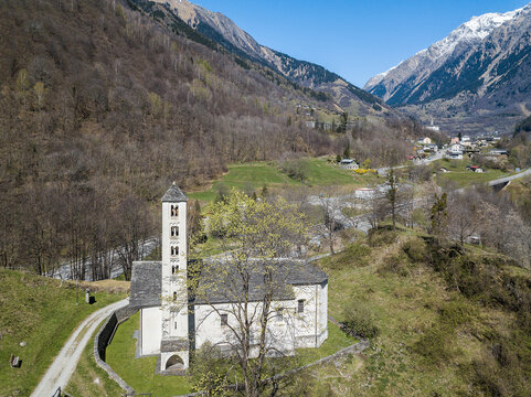 The catholic church of Santa Maria del Castello under the foot of Mesocco ruins. The Mesocco town is at the far background.