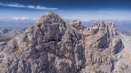 9 September 2025, Durmitor park, Montenegro: Hikers standing on a rocky peak Bobotov Kuk, celebrating achievement