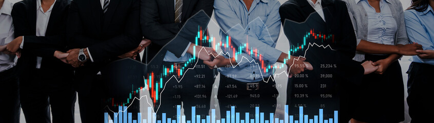 Group of diverse professionals stands together, analyzing financial graphs and data trends, embodying teamwork and collaboration in a modern business setting. Scalp © InfiniteFlow