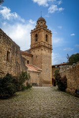 Fototapeta premium Vertical photo of the bell tower of the church of Santa Margarita in Mirambel, Teruel, Aragon, Spain