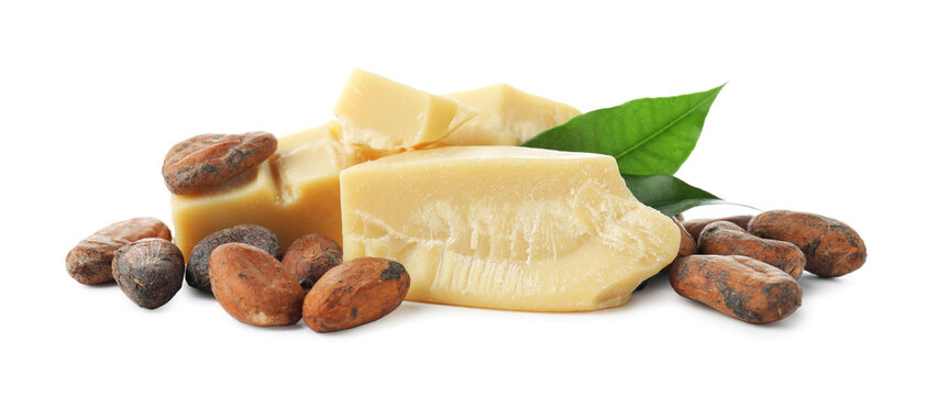 Organic cocoa butter, beans and green leaves isolated on white