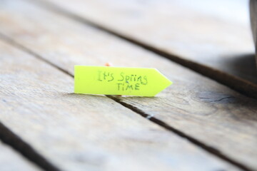 Its spring time tag on a wooden background.