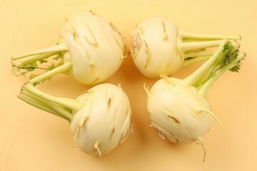 Freshly harvested kohlrabi ready for the market captured on a bright yellow backdrop showcasing their vibrant textures