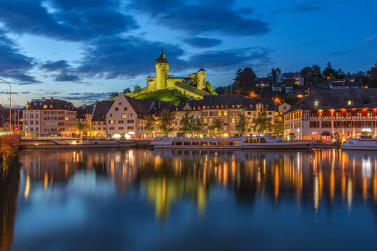 The medieval fortress Munot on the Rhine river with cruise ships in twilight, schaffhausen, Switzerland