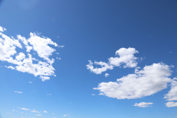Bright Blue Sky with White Puffy Clouds Background