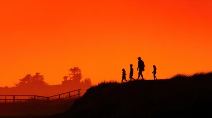 Fototapeta premium Family walking together at sunset on grassy hill